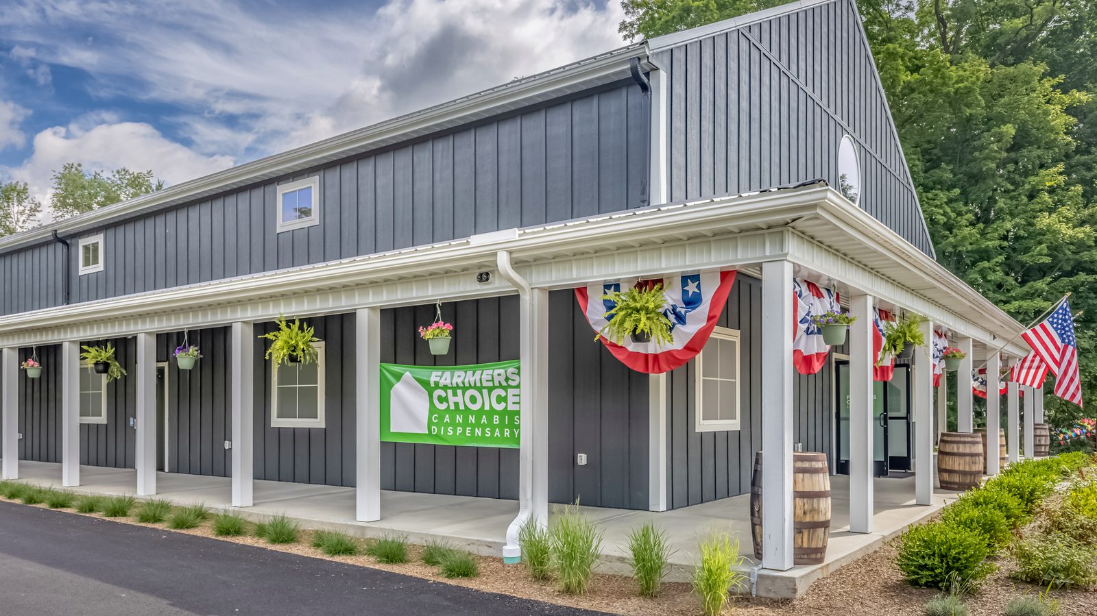 The Farmers Choice New Paltz porch wrapped in July 4th bunting with hanging flower baskets